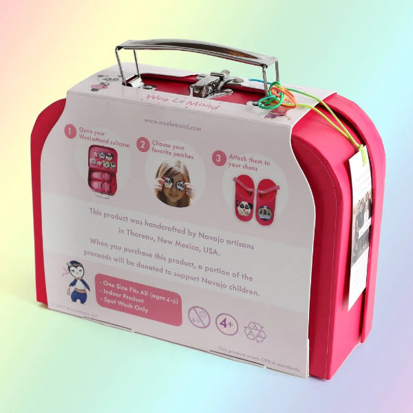 Pink toy suitcase with labels and images on a gradient background