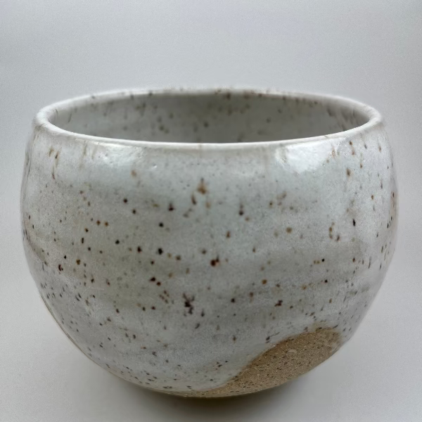 Speckled ceramic bowl on a white background