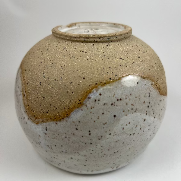 Speckled ceramic vase on a white background