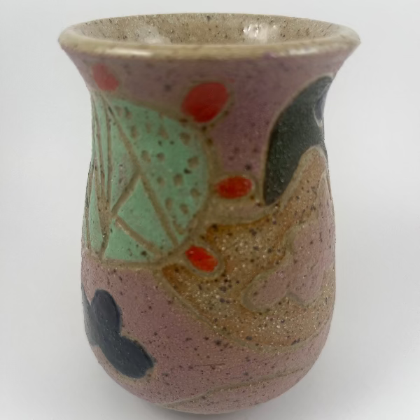Handmade ceramic vase with abstract design on a white background