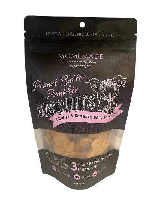 A stand-up pouch of Homemade by Mom Peanut Butter Pumpkin Biscuits dog treats on a plain white background. The black resealable bag has a clear window showing the treats inside and white and pink text and graphics.