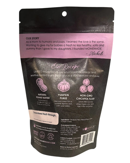 Back view of a matte black stand-up pouch for dog treats, featuring a pink 'Our Story' banner and product ingredient illustrations on a white background.