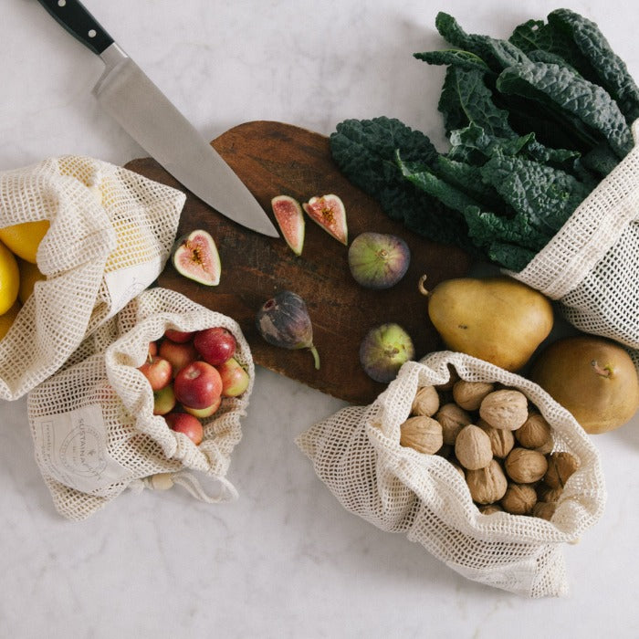 a cutting board topped with fruits and vegetables