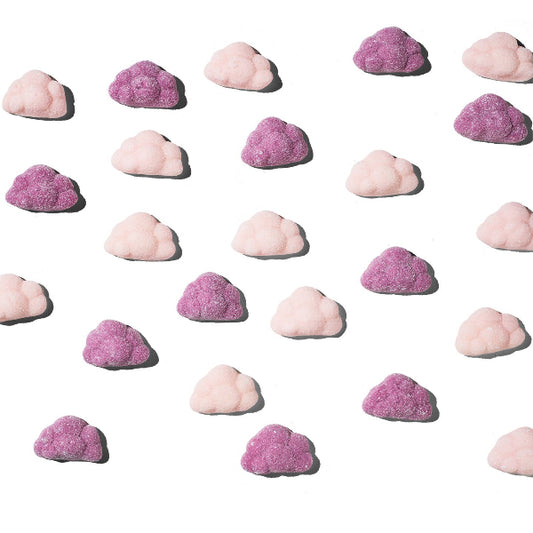 Pattern of pink and purple cloud-shaped candies on a white background