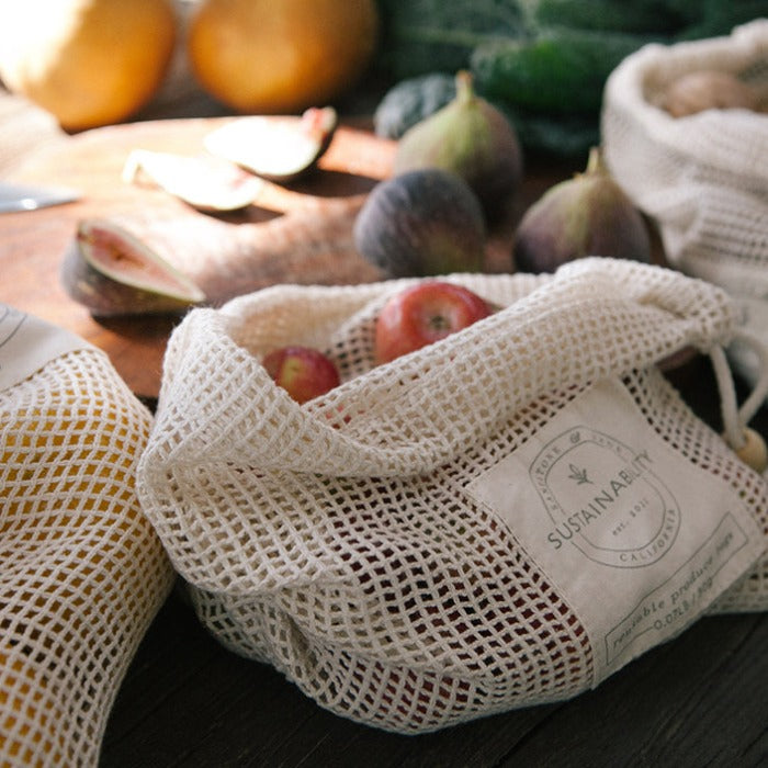 a bag of fruit sitting on top of a wooden table