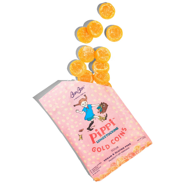 Pink bag of Pippi Gold Coins candy with orange gummy candies spilling out on a white background