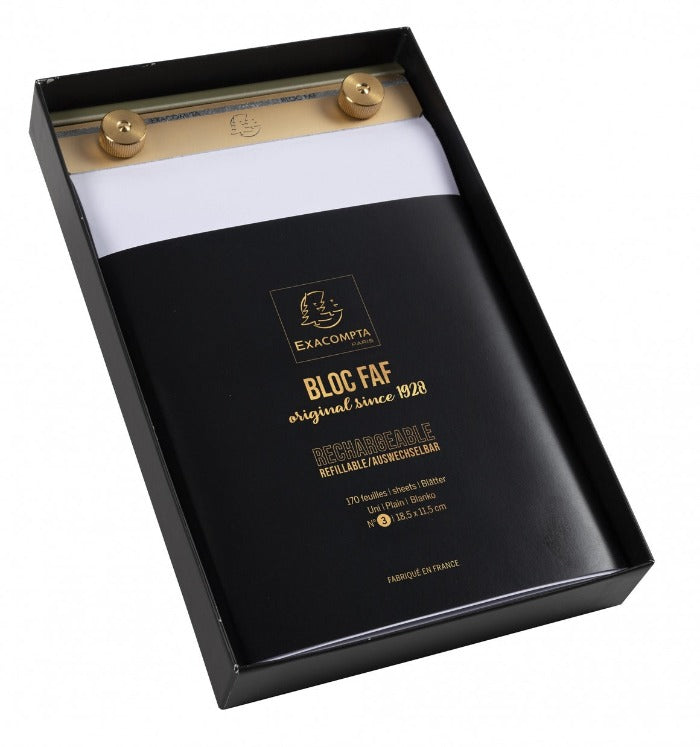 a black and gold box with a white sheet of paper in it