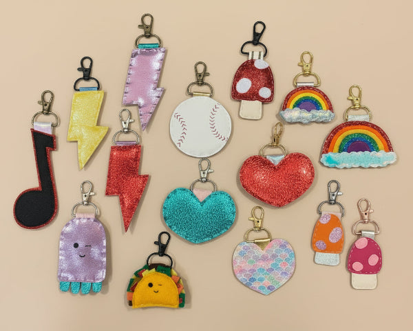 Collection of colorful keychains on a beige background