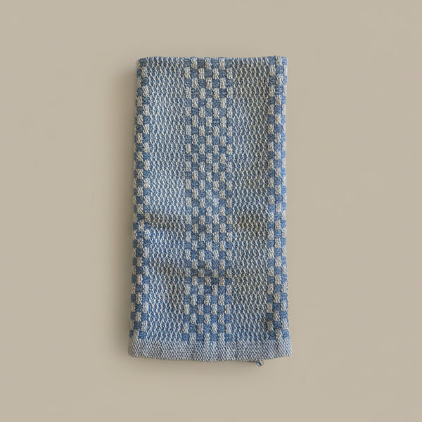 Blue and white checkered fabric on a marble surface