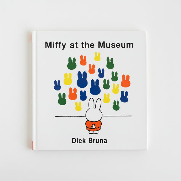 Book titled 'Miffy at the Museum' by Dick Bruna on a wooden surface