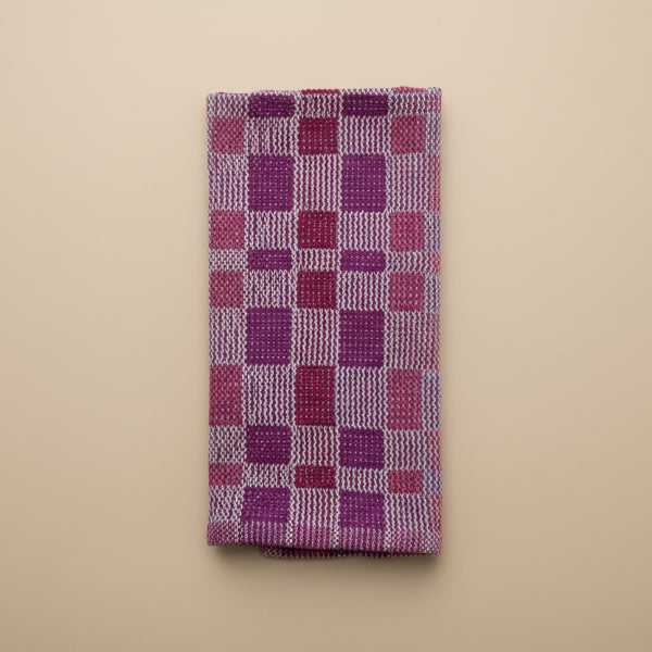 Rectangular woven mat with a checkered pattern on a marble surface