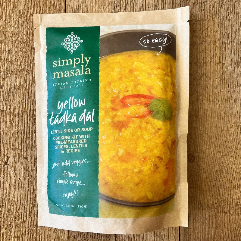 Packaging of Yellow Tadka Dal lentil soup mix by Simply Masala, with a green and white label, visible spices, and the product described as a main dish or soup base.